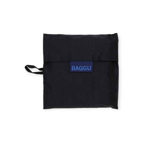 The Baggu Standard Reusable Bag in black, designed by the brand Baggu, is a compact square tote made from recycled nylon and features a small strap on the side.