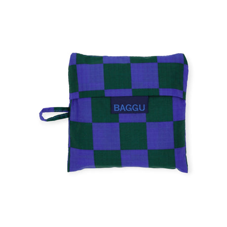 A Baggu Standard Reusable Bag - Iris Green Check in a vibrant green and purple checkered pattern, crafted from recycled nylon, featuring a convenient small handle on the side.