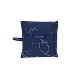 The Baggu Standard Reusable Bag - Constellation, made by Baggu from recycled nylon, neatly folds into a square pouch. Featuring constellation prints and the iconic "BAGGU" label on the front, it is both stylish and eco-friendly.