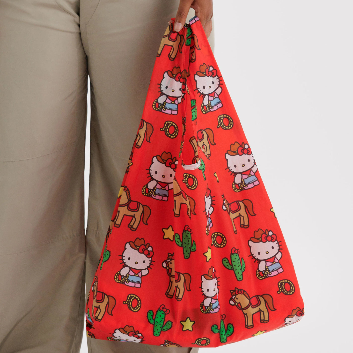 Red printed drawstring tote bag with Hello Kitty figures and cactus graphics