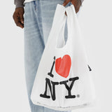 White tote bag being carried, with I ♥ NY heart and lettering front