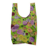 The Big Baggu Bag - Dahlia by Baggu is a green reusable bag adorned with a vibrant dahlia print showcasing pink, yellow, and purple flowers. It's crafted from recycled nylon for an eco-friendly appeal.