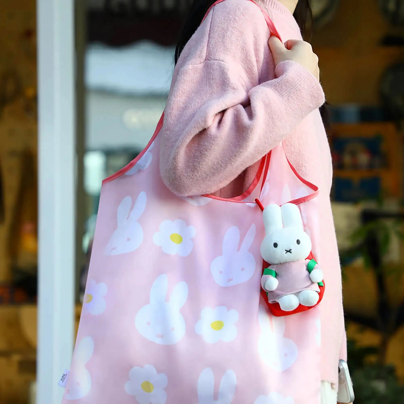 Pink plush bunny tote bag with floral print and small bunny keychain charm