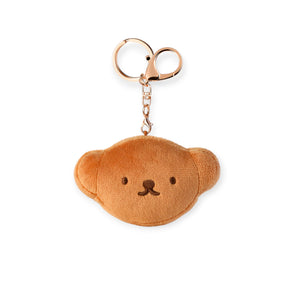 Plush brown bear face keychain with simple embroidered eyes and nose attached to gold-toned metal ring and clasp