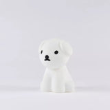 The Snuffy Dog Miffy Night Light, measuring 15cm, by the Miffy brand is a small, white dog figurine with cartoon-style design. Made from BPA-free silicone, it features black eyes and a nose that perfectly embodies the charming essence of Miffy and Friends against a plain background.