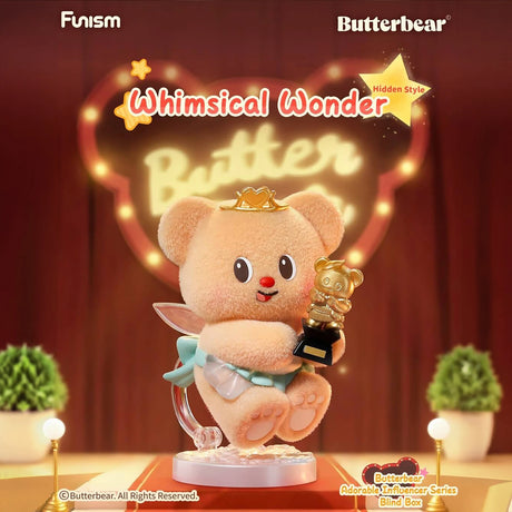 Fluffy bear figurine wearing crown and cape holding golden bear trophy on illuminated stage with red curtains background