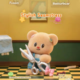 Butterbear blind box figure: plush bear with scissors and tape, wearing a blue apron