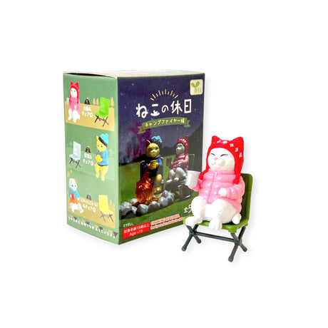 White cat figurine in red hooded jacket sitting on green camping chair with Campfire Friends Blind Box packaging, gallery 1
