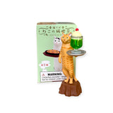 The Mofusand Cat Cafe Waiter Blind Box features a cat figurine holding a tray with a green dessert. The design highlights cats, and the packaging warns: "CHOKING HAZARD—Small parts. Not for children under 3 yrs.