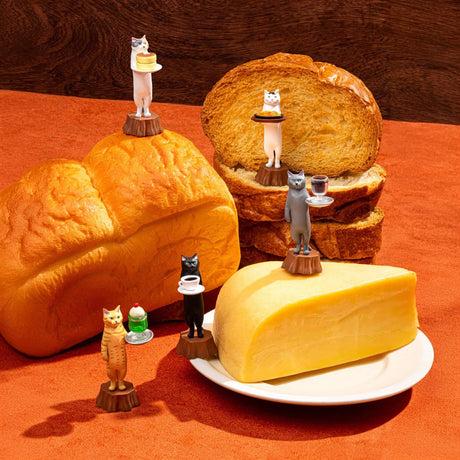 The Mofusand Cat Cafe Waiter Blind Box features small cat figurines charmingly posed with miniature plates and drinks, sitting atop a loaf of bread, slices, and a block of cheese on a plate.