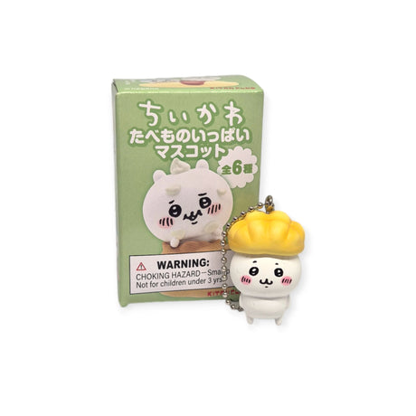 The Yell Chiikawa Food Keychain Blind Box features a charming character wearing a dumpling hat, making it an ideal accessory for any foodie costume. Its packaging resembles a blind box and includes another delightful illustration, along with safety warnings in both Japanese and English.