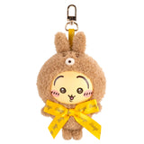Brown teddy bear plush keychain with yellow ribbon and metal clip, smiling face.