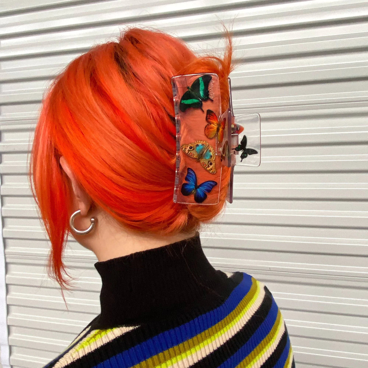 Butterfly box claw clip clipped to bright orange hair