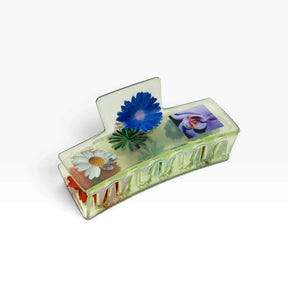 Transparent claw clip with blue and white daisies and red flower detail