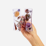 Seashell box claw clip shown in hand, clear lavender frame with seashell and starfish charms