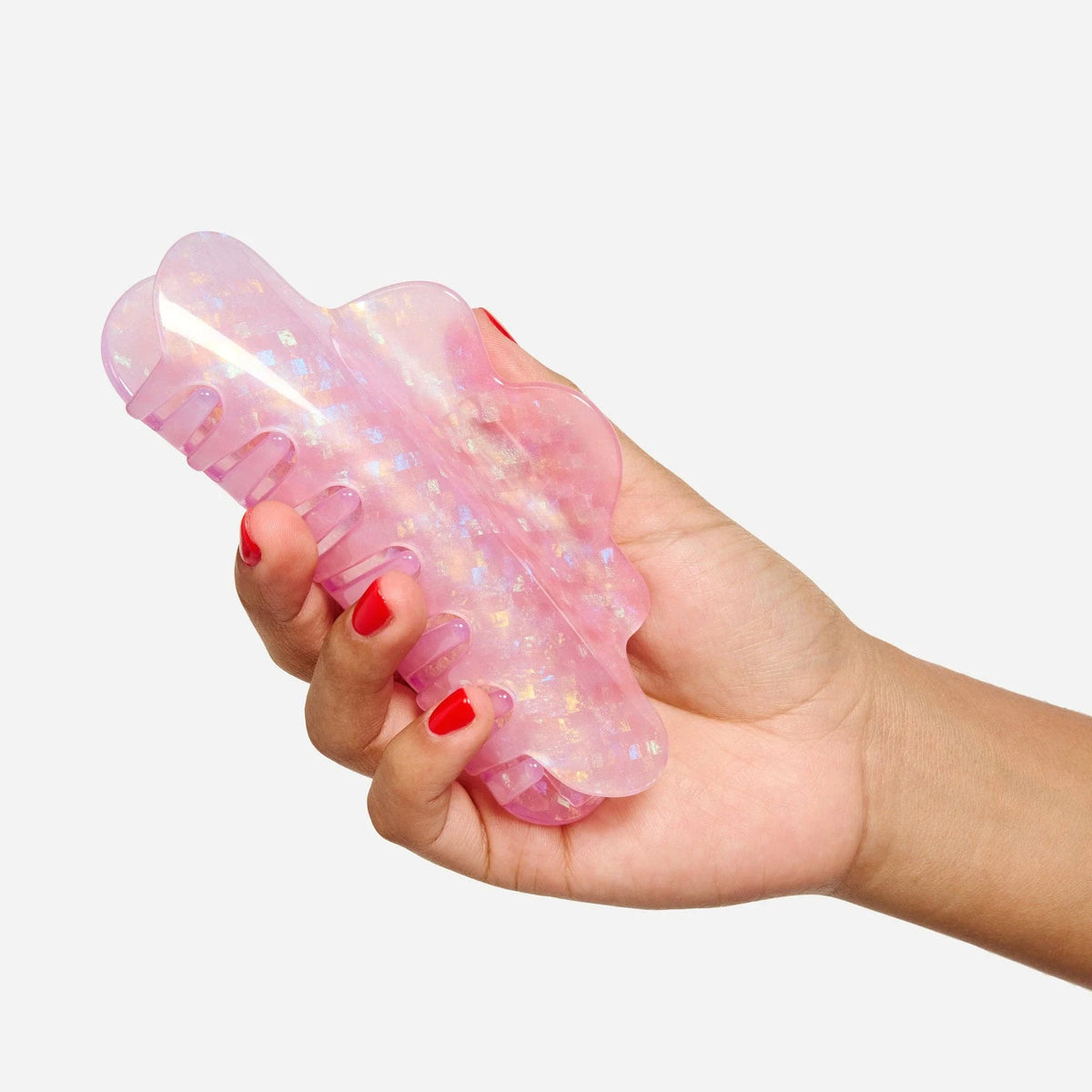 Iridescent lilac glitter claw hair clip held open, showing gripping teeth