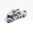 Translucent milk-jelly claw clip with dark purple and blue marbling, curved teeth.
