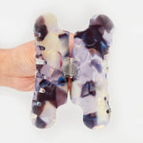 Pair of translucent claw clip prongs in milk-jelly swirls of purple, blue, and cream.