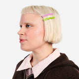 Two wavy hair slide clips (lilac and lime) on blonde hair