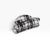 Chunky black-and-white plaid claw clip with ridged grip teeth