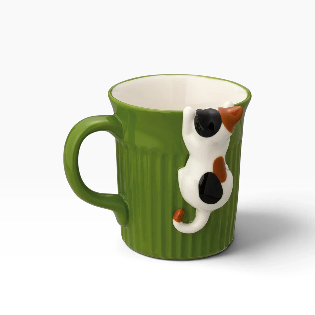 Green ceramic mug with calico cat face and tail decoration on side, white interior