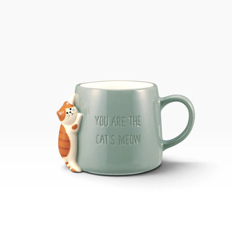 Light blue cat mug with white cat illustration and 'Cat's Meow' quote
