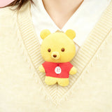 Yellow bear plush charm with red outfit and small button nose