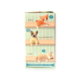 The Resting Dogs Blind Box - Vol. 2 by Yell features miniature figurines of three dog breeds labeled in Japanese: Chihuahua, French Bulldog, and Corgi, stacked from top to bottom. Ideal as Doggy Desk Buddies, be sure to collect all five breeds for the full collection!