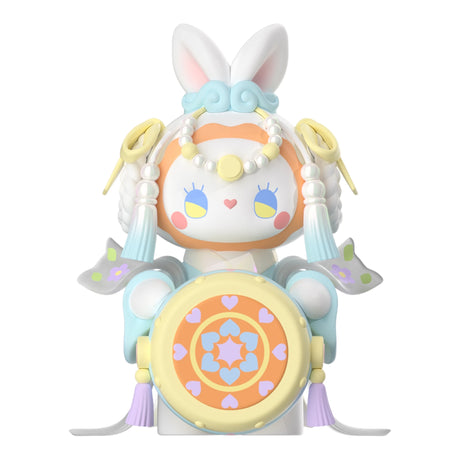 This adorable and vibrant bunny-themed figurine from the Lucky EMMA - Secret Forest of Dim Lights Series Blind Box features a charming crown, heart accents, and ornate elements reminiscent of wings and tassels. Discover it as a delightful surprise within the Lucky Emma collection!