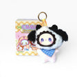Fuzzy plush keychain with black-and-white panda face, blue plaid outfit, gold ring
