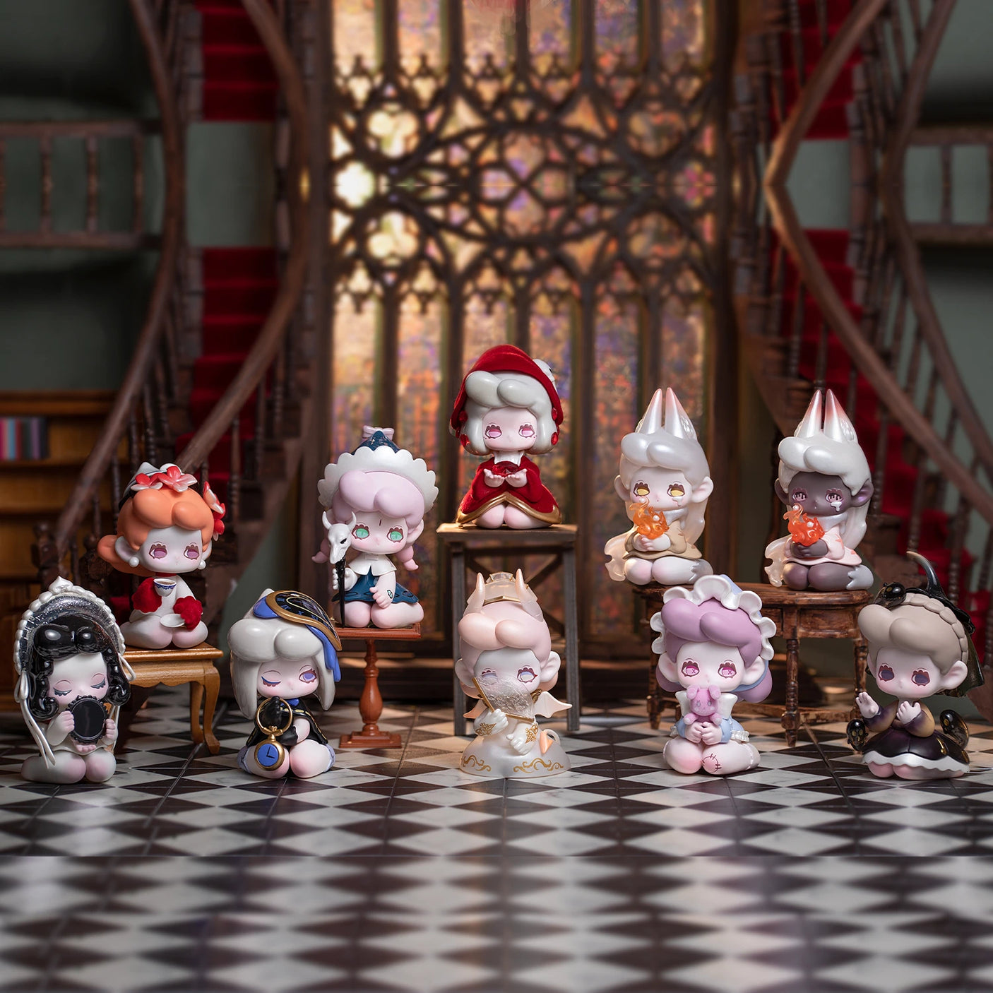 A collection of ten adorable small figurines from the Lucky Emma Killa Treasure Pavilion Blind Box series is displayed on a checkered floor in a room adorned with ornate decor, with a grand staircase in the background.