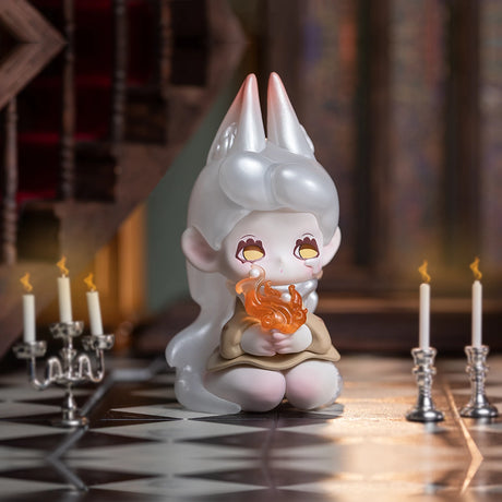 A figure with long white hair and horns sits on a checkered floor, holding a small flame, surrounded by lit candles in ornate candlesticks. This scene captures the mysterious allure reminiscent of the hidden wonders within the Lucky EMMA - Killa Treasure Pavilion Blind Box by Lucky Emma.