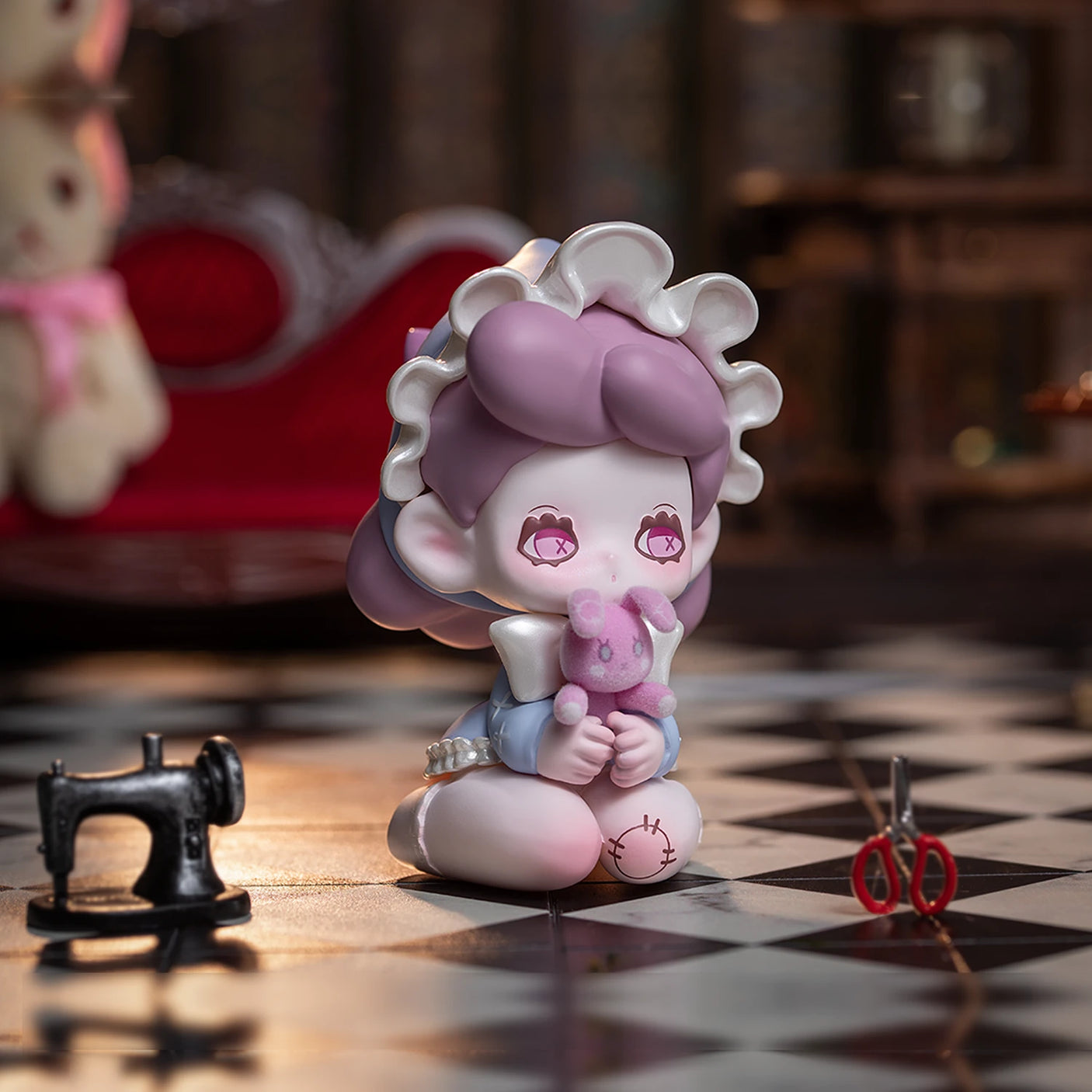 A doll with purple hair and a white bonnet sits on a checkered floor, holding a small stuffed toy from the Lucky EMMA - Killa Treasure Pavilion Blind Box by Lucky Emma. Nearby are sewing tools, including a miniature sewing machine and scissors, reminiscent of treasures from the Killa Treasure Pavilion.