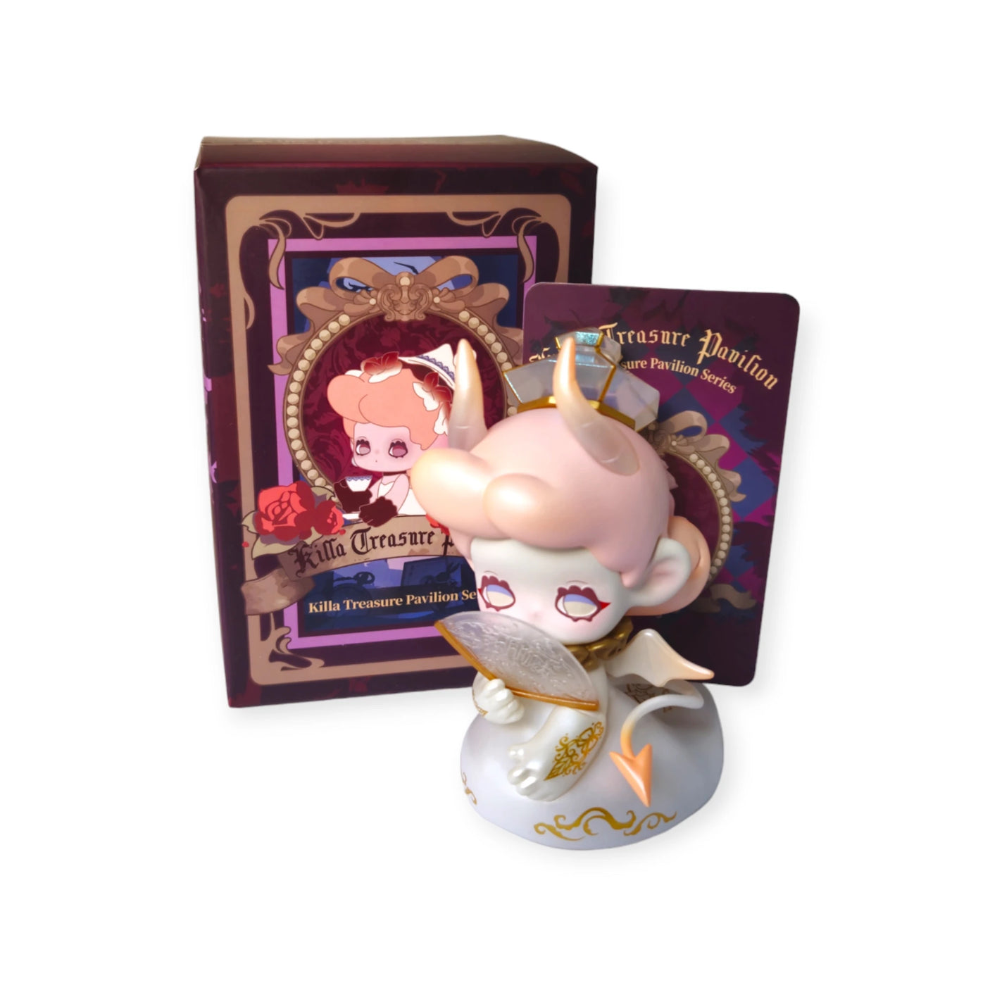 A Lucky EMMA figurine, featuring horns and holding a feather and a card, stands before a decorative box inspired by the Killa Treasure Pavilion Blind Box from the brand Lucky Emma.