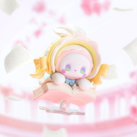 Emma Secret Forest Love Dopamine figure with yellow ribbons, white bonnet, and pink book floating with flying pages background