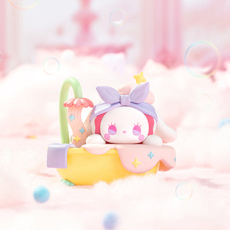 Pastel Emma Secret Forest Love Dopamine figure with star details lounging in a yellow bathtub on soft pink fluffy background