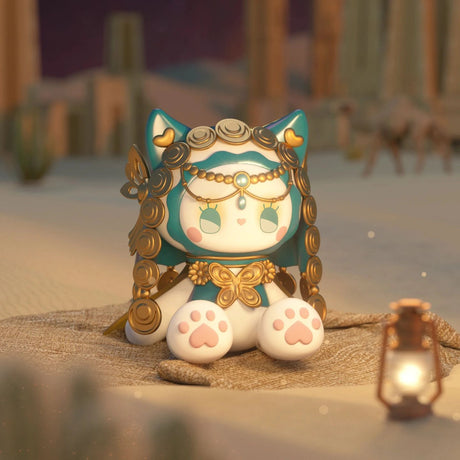 A charming figurine from the Lucky EMMA - Secret Forest River of Time Blind Box series features a cute cat with a turquoise headpiece and golden accents, posed on sand beside a lantern in a desert landscape. This captivating piece is ideal for collectors who appreciate the allure of the Lucky Emma figures.