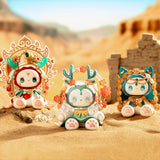 Three adorable figurines from the Lucky Emma - Secret Forest River of Time series are adorned in intricate costumes and set against a backdrop of desert sand with ancient ruins. Discover their mysteries as you open each blind box and uncover the hidden tales of Lucky Emma figures waiting to be revealed.