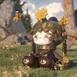 A stylized cartoon figure from the Lucky Emma brand's Secret Forest River of Time collection is seated on grass, adorned with a headdress featuring yellow flowers while admiring a butterfly. The figure's white face is embellished with a heart-shaped design, and its clothing features smiley faces in this whimsical blind box series.