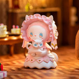 This delightful Lucky Emma creation from the Secret Forest Birthday Party Blind Box series features a hand-painted figurine of an endearing character in a pink bonnet, gently holding a small cat. The inviting scene is completed by a cozy room with a table and presents, bringing the enchanting atmosphere of a Secret Forest Birthday Party to life.