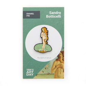 Enamel pin featuring Venus standing on a green seashell, gold hair and black outline