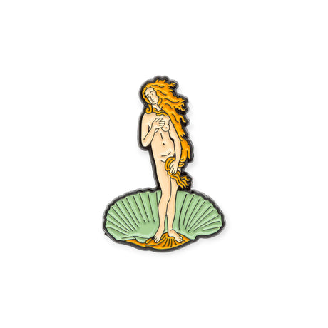 Enamel pin of Venus standing on a green seashell with gold hair and orange highlights