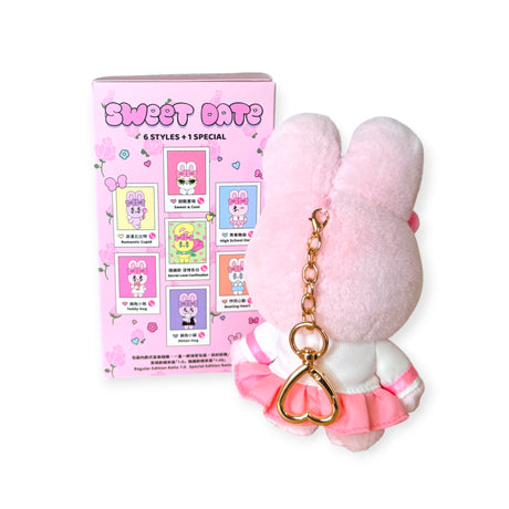 Pink Esther Bunny plush keychain with heart-shaped gold chain placed beside a pastel pink Sweet Date blind box packaging