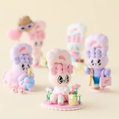 Set of pastel bunny figurines with shopping bags and flowers on display