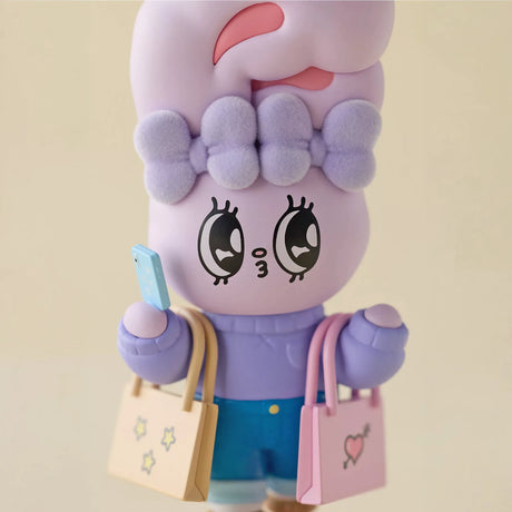 Lavender bunny figurine close-up with face and shopping bags, wearing blue pants