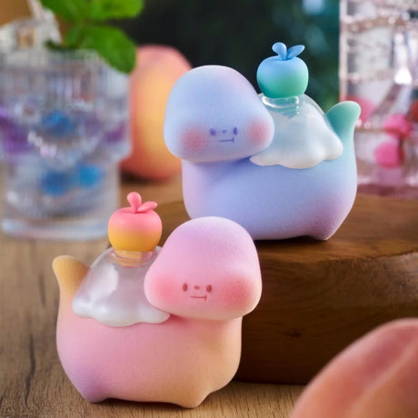 Two pastel Food Dinosaur Fuji Yama Vol. 2 blind box figures with syrup and fruit toppings on wooden surface