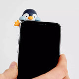 Phone case with penguin-shaped charm on the back