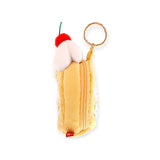 Tall yellow plush zip pouch with white frosting top, red cherry, and gold keyring