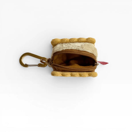 Plush cookie-shaped AirPods case with open zipper and metal carabiner clip