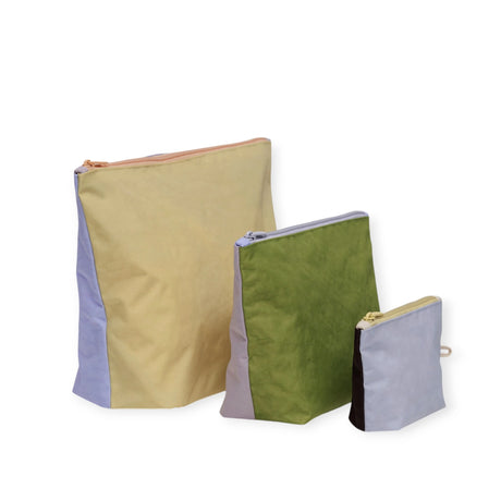 Explore the Baggu Go Pouch Set - Pastels, featuring three zippered pouches made from recycled materials. Available in charming pastel shades of yellow, green, and gray, these pouches combine stylish convenience in different sizes.